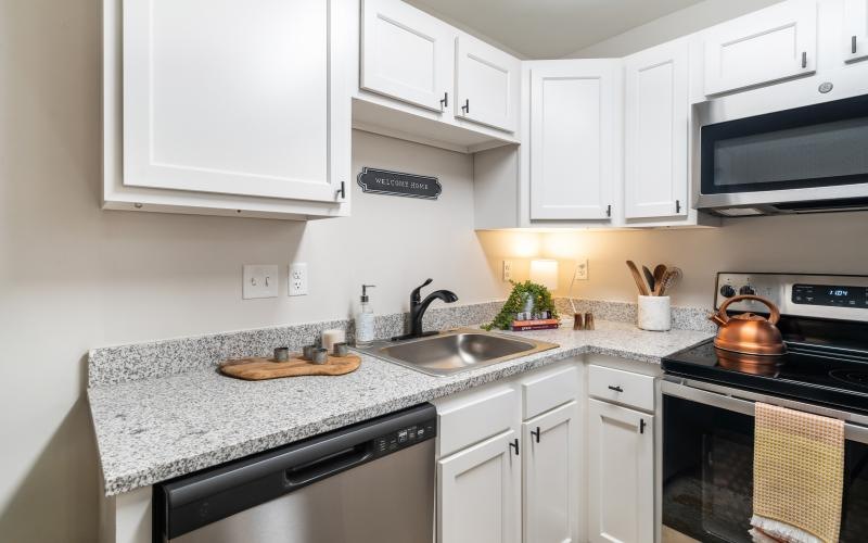 a kitchen with white cabinets