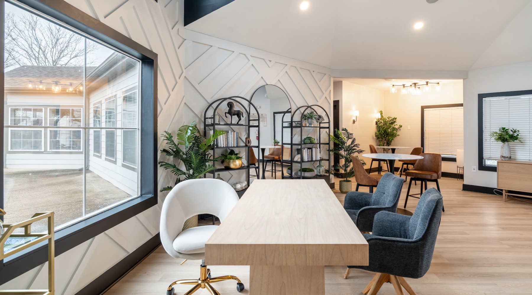 a room with a table chairs and a window