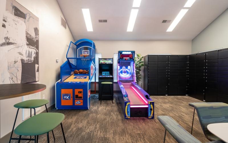 a room with a play set and chairs